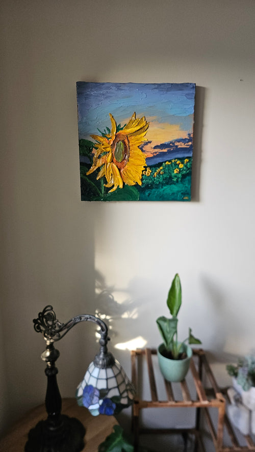 Painting of a field of sunflowers at sunset