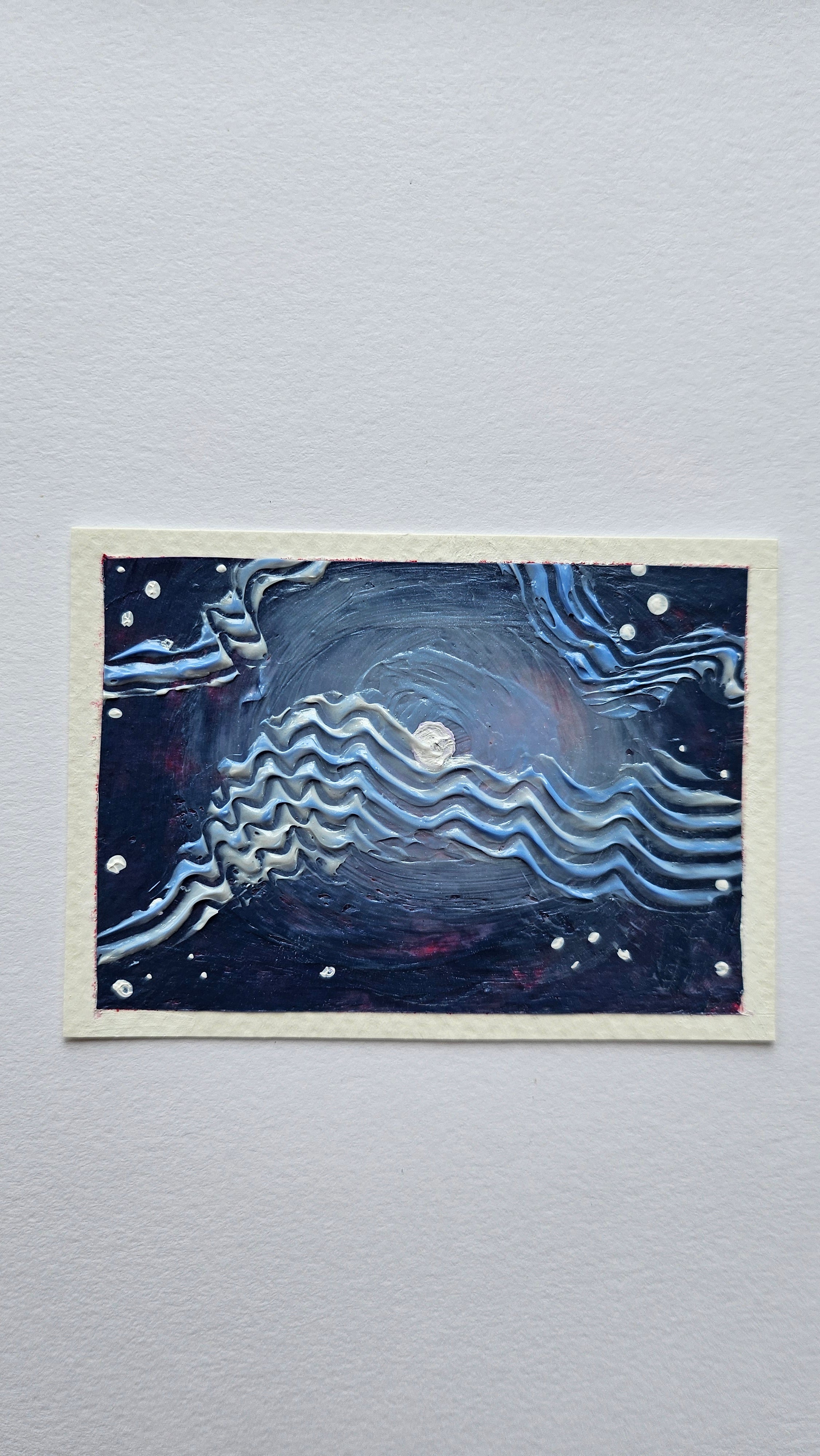 Mini painting of the moon with wispy clouds