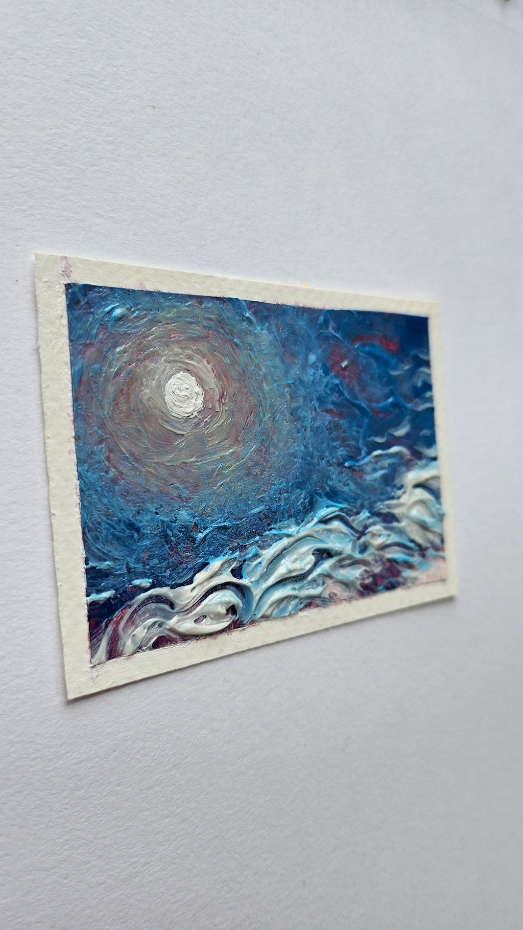 Mini painting of the sun and high clouds