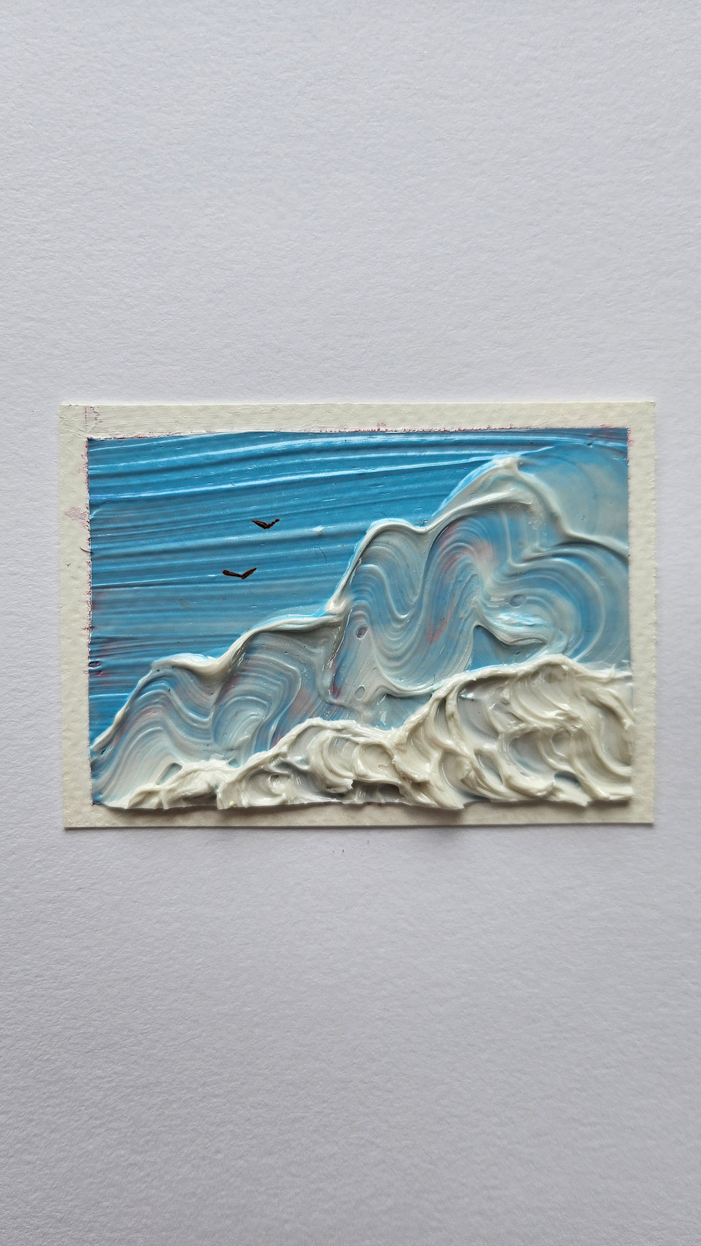 Mini painting of birds flying above clouds