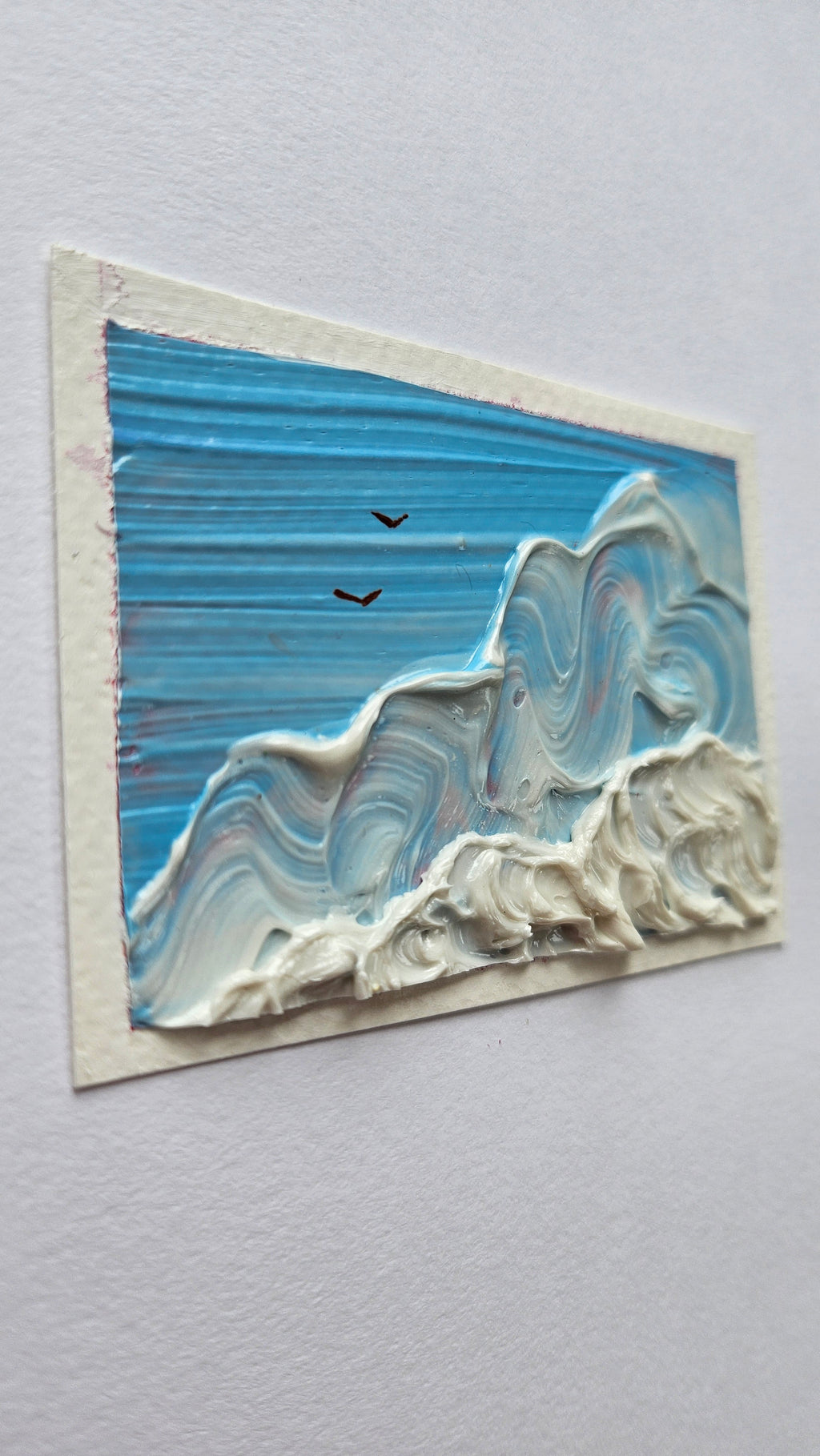 Mini painting of birds flying above clouds