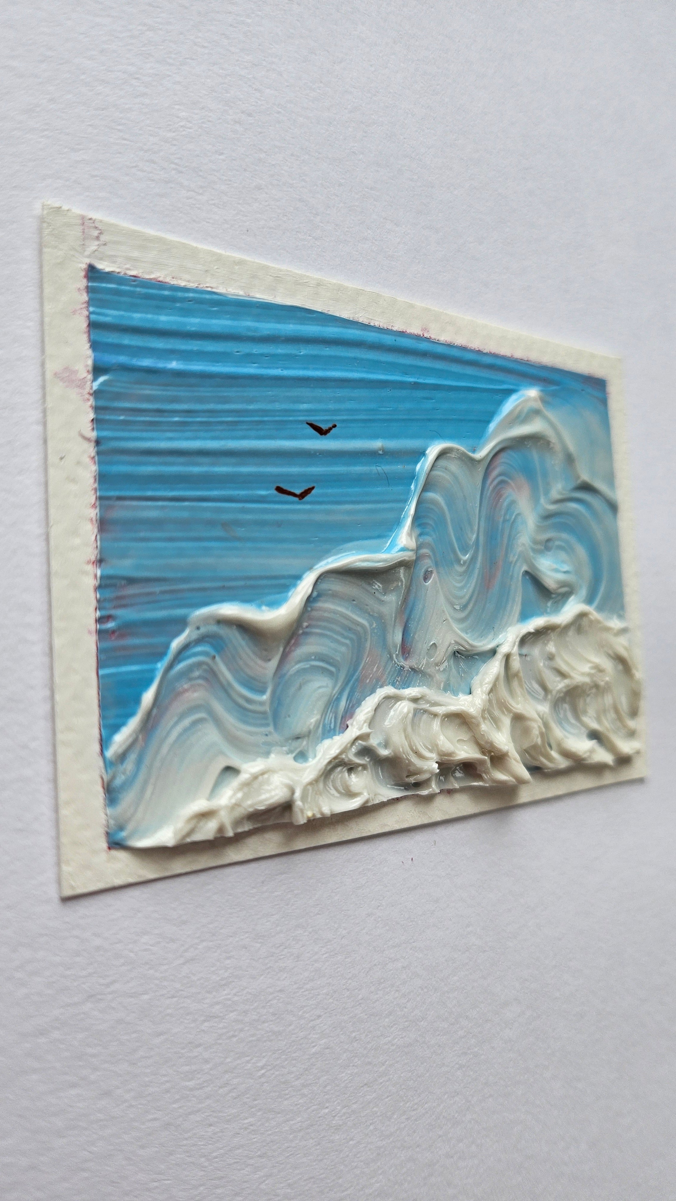 Mini painting of birds flying above clouds