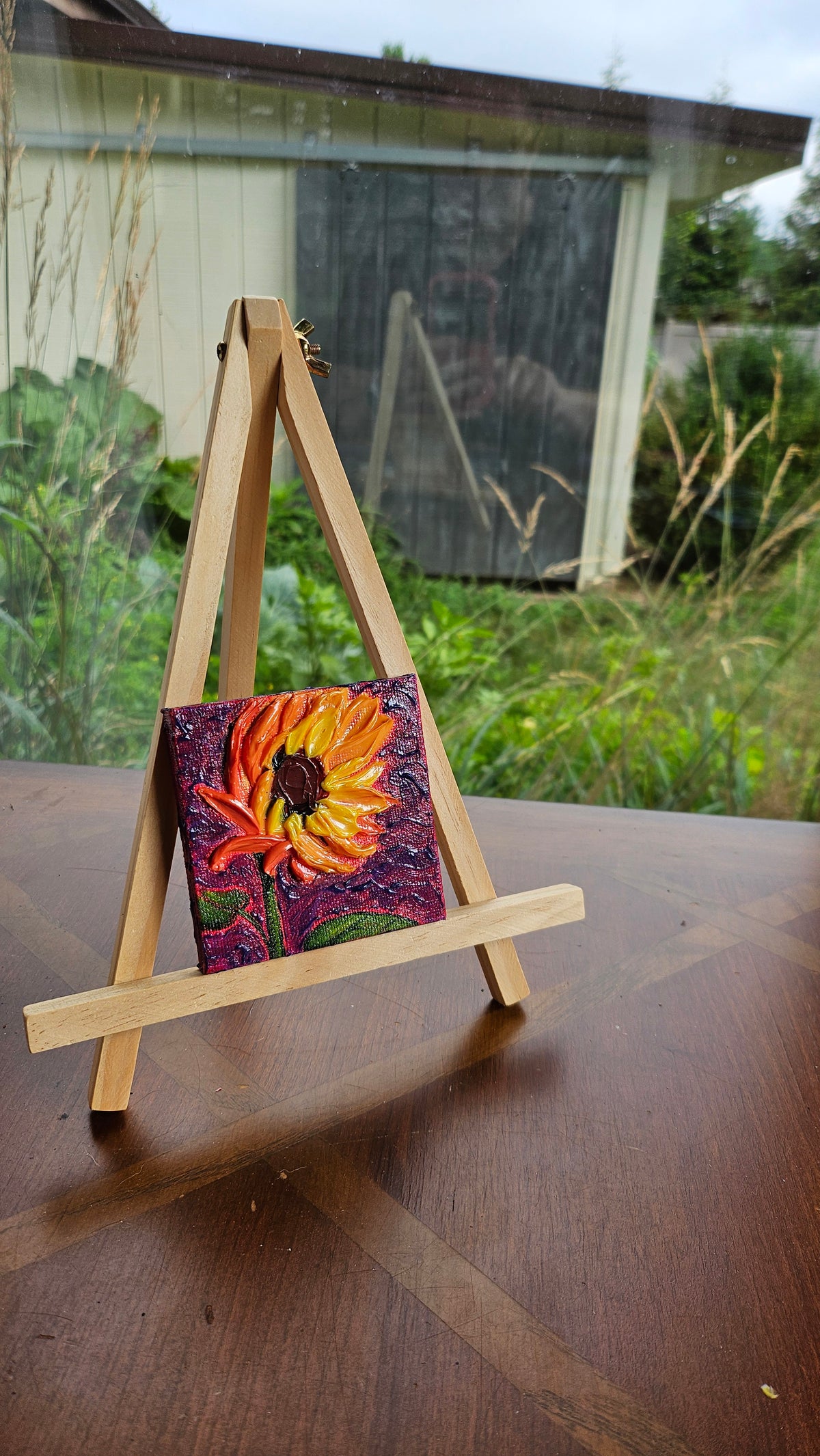 Mini painting of a sunflower at sunset