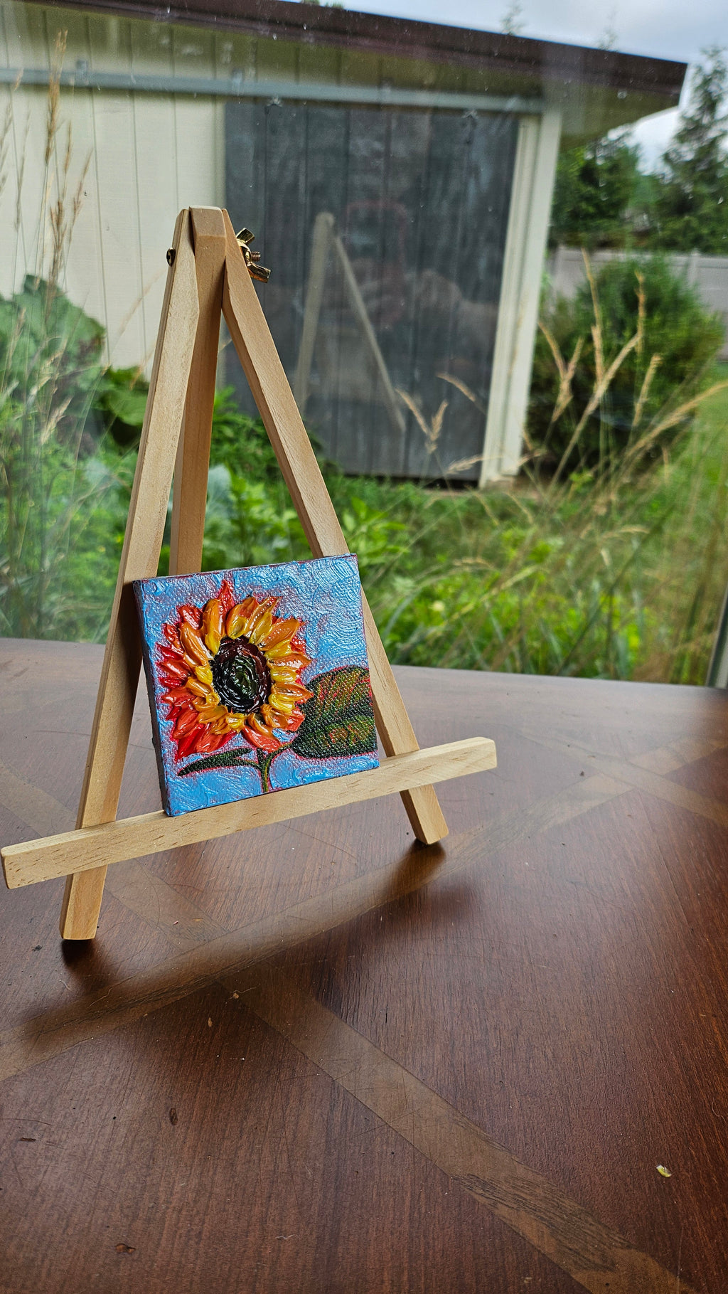Mini painting of a sunflower and a blue sky