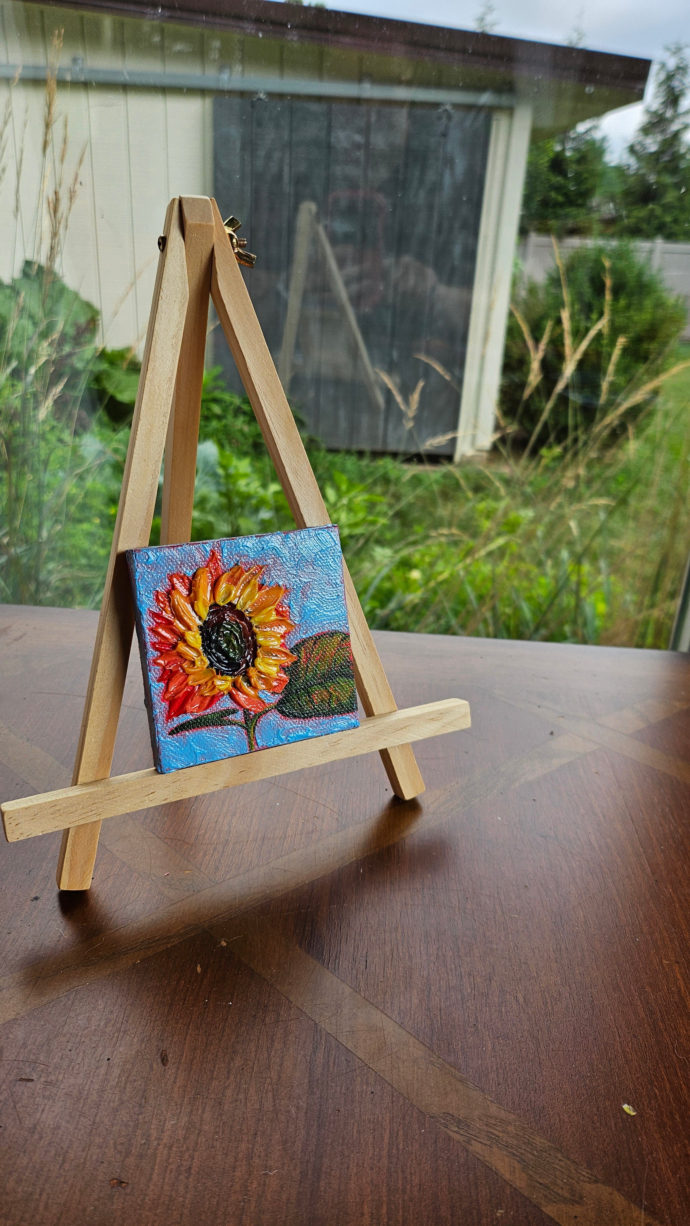 Mini painting of a sunflower and a blue sky