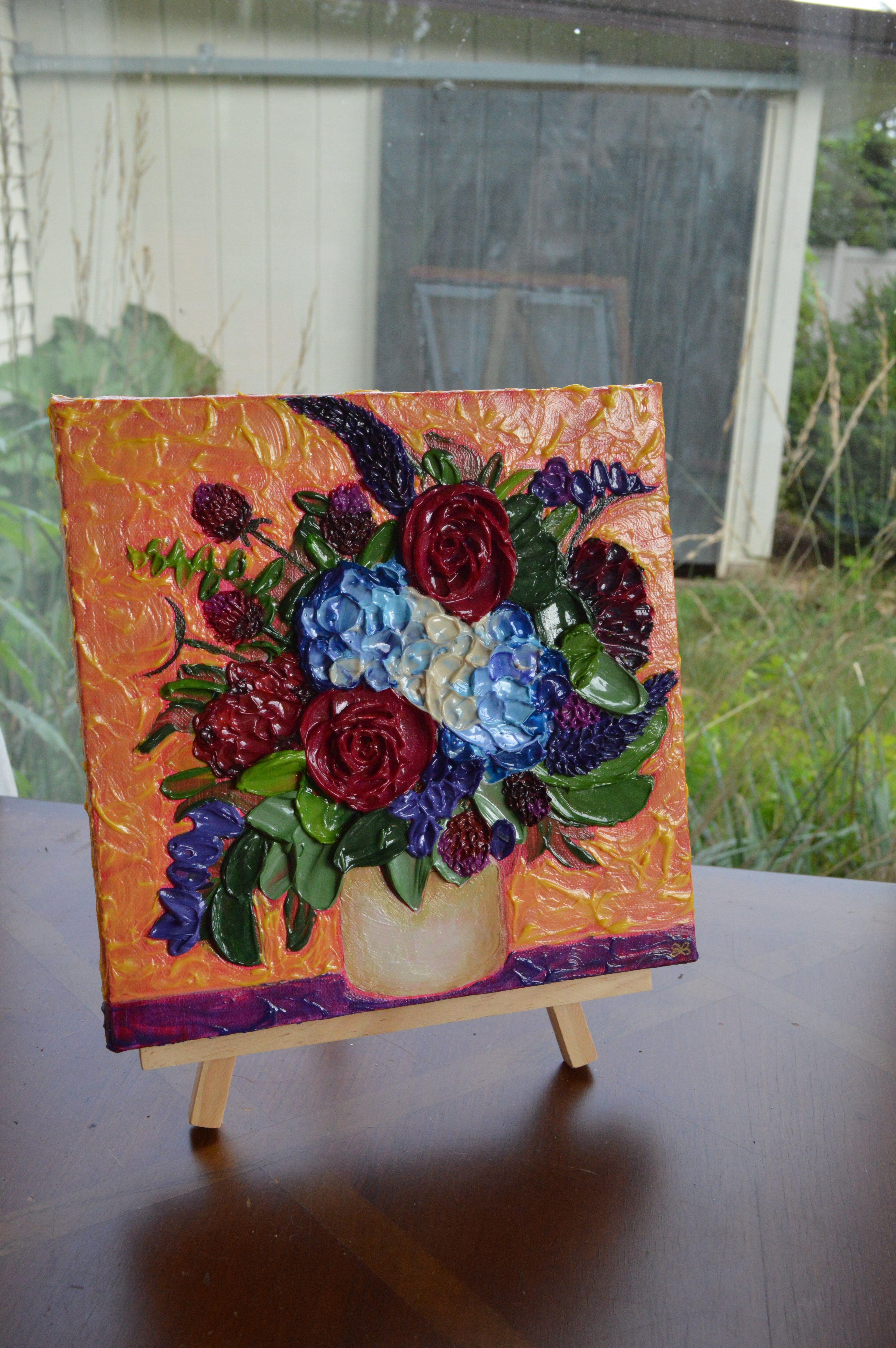 Painting of a blue, red, and purple bouquet