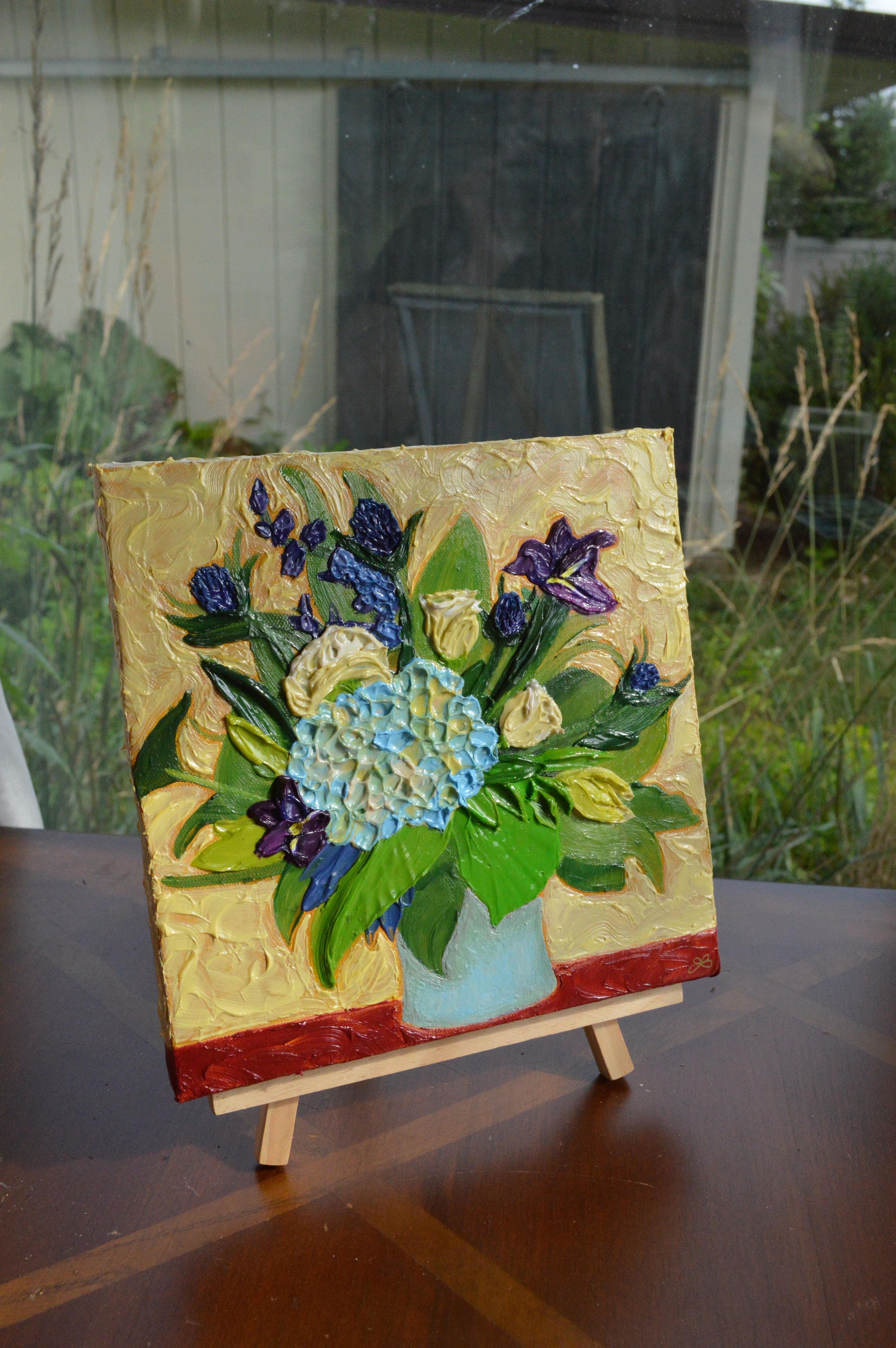 Painting of a blue and purple bouquet