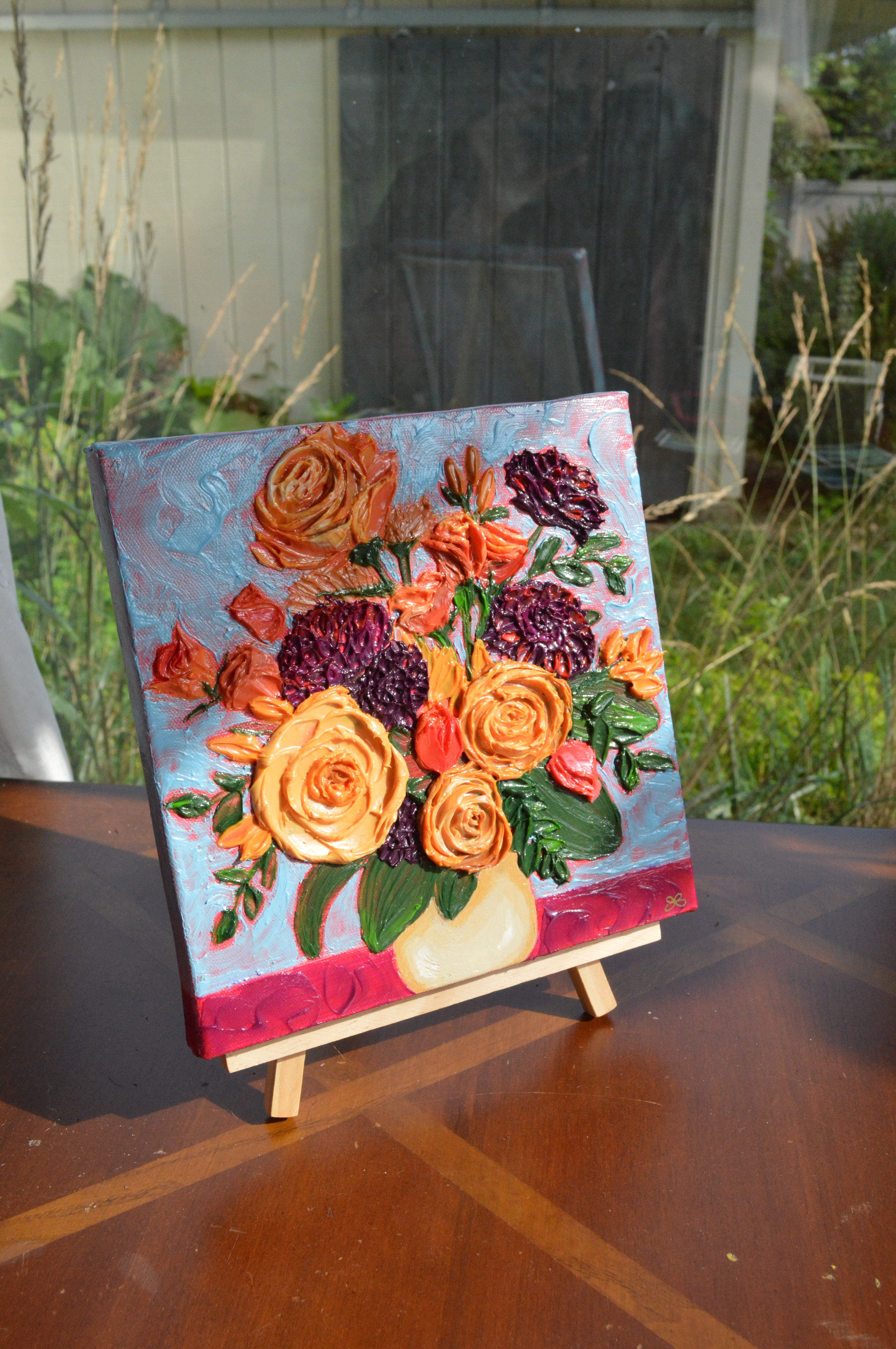 Painting of an orange, yellow, and purple bouquet