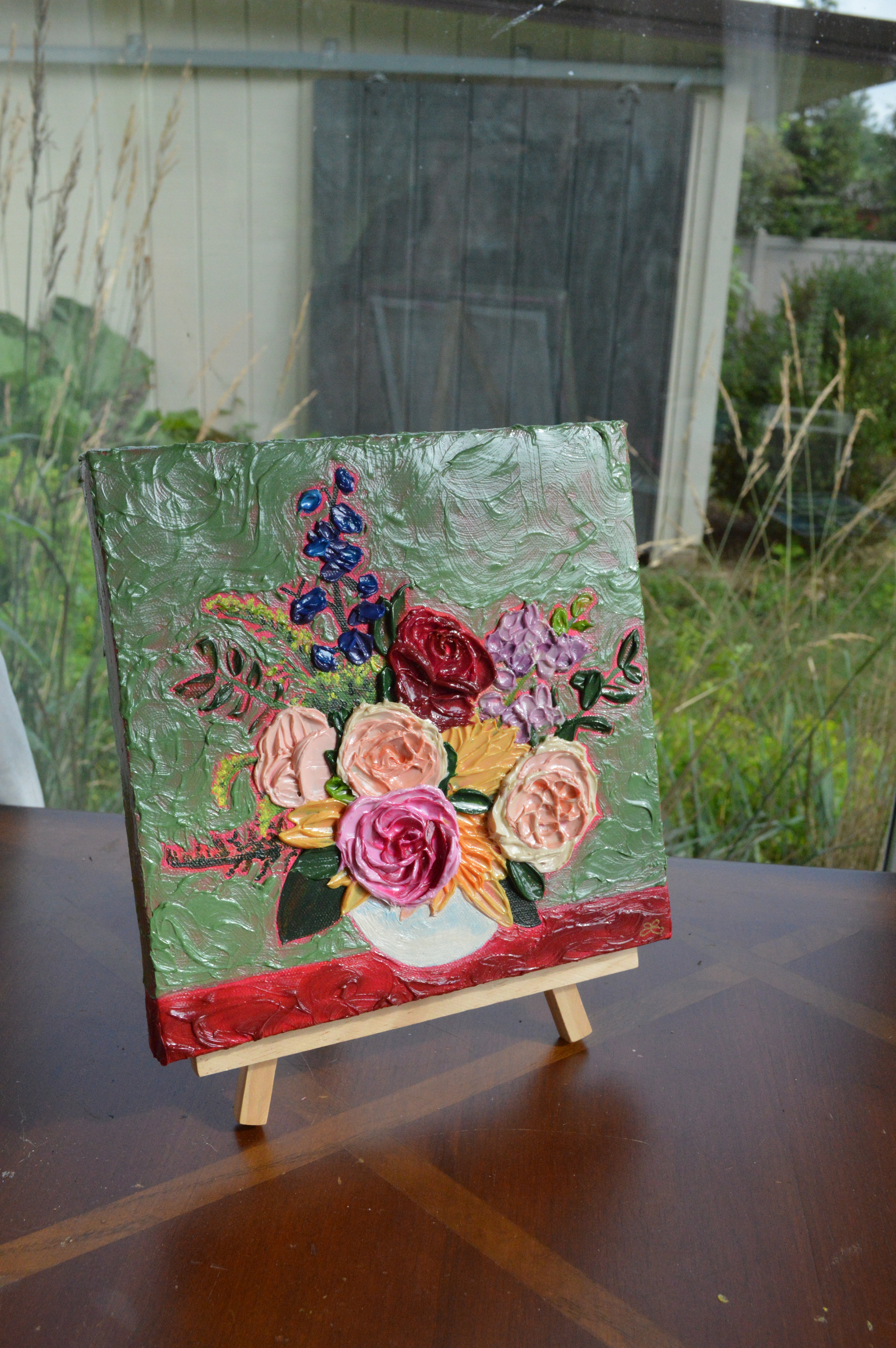 Painting of a pink, red, and blue bouquet