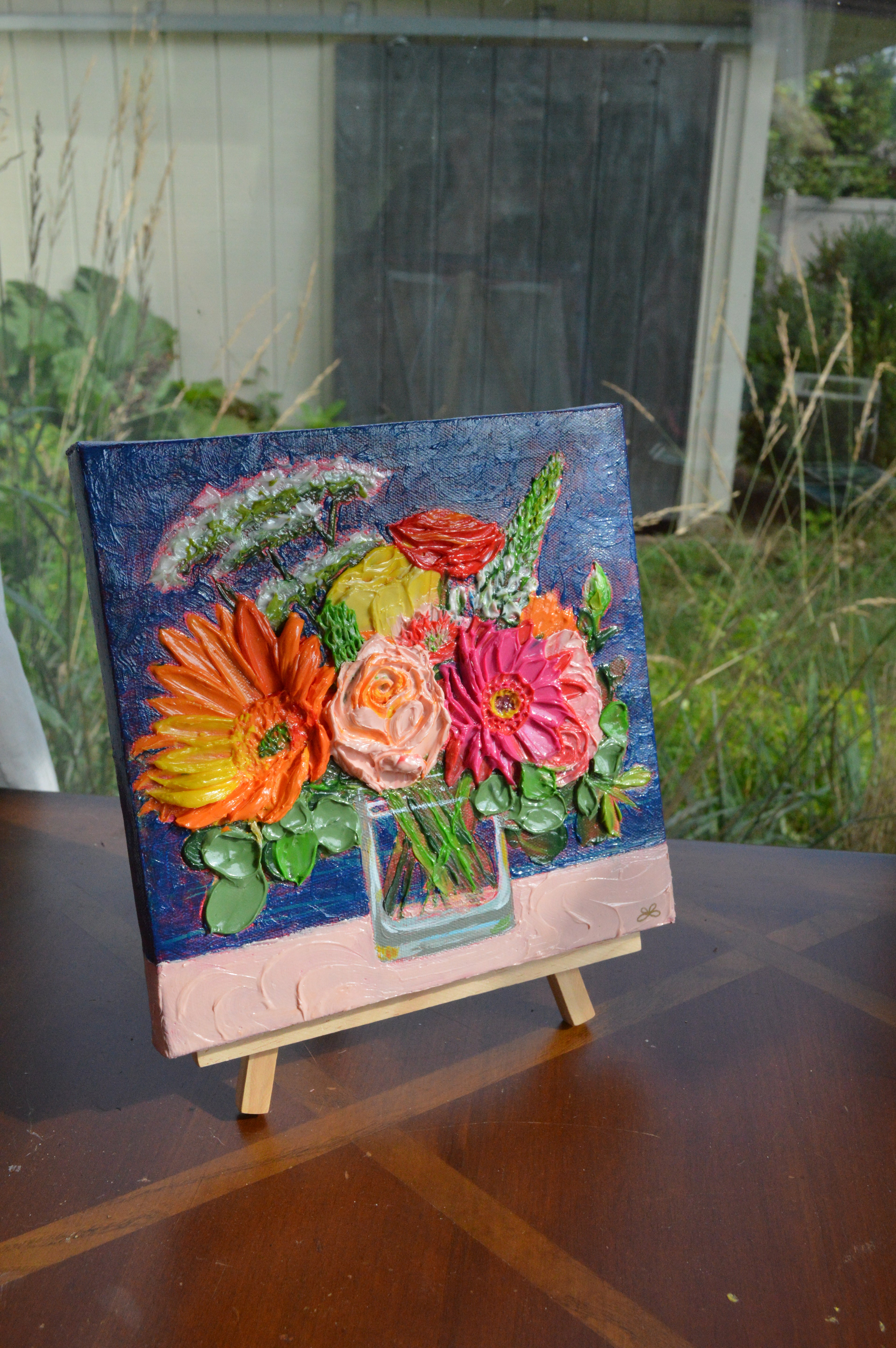 Painting of an orange and pink bouquet
